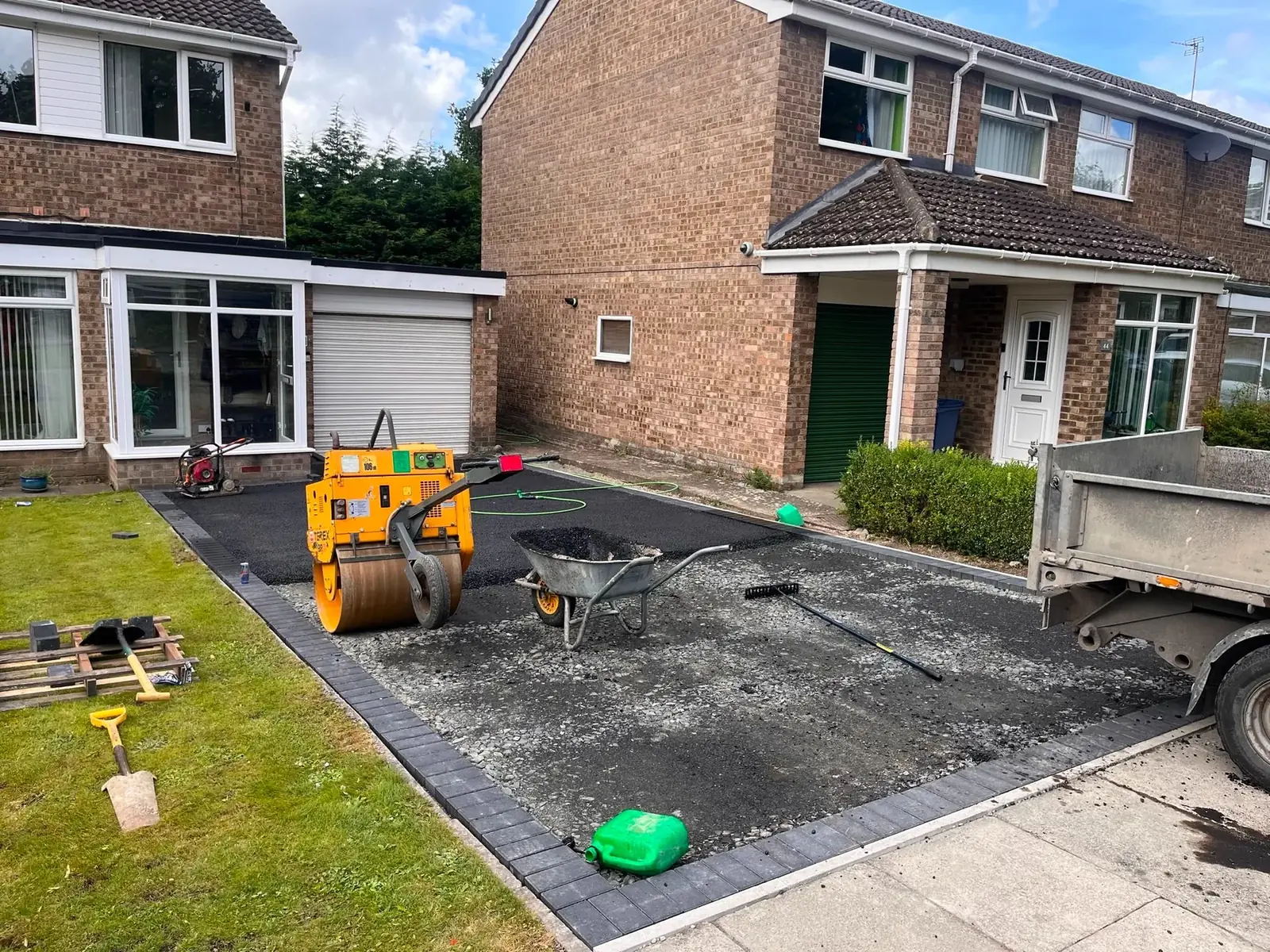 Surfacing machinery laying and rolling the base at a semi-detached Newcastle driveway