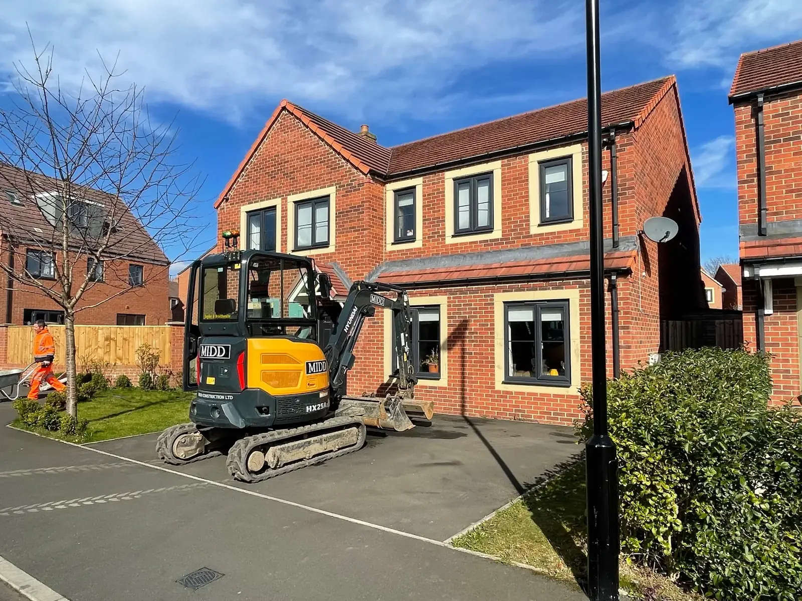 Excavation work under way with a mini digger before a new driveway at a modern Newcastle home